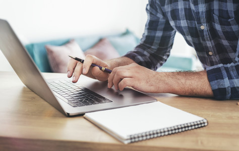 Male student studying online using laptop. Online education concept